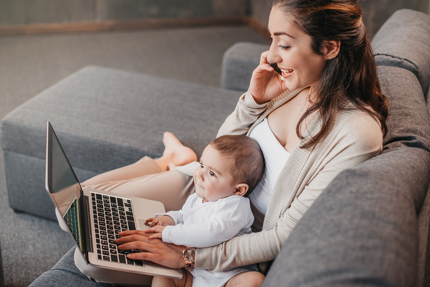 Mother working from home with child in lap