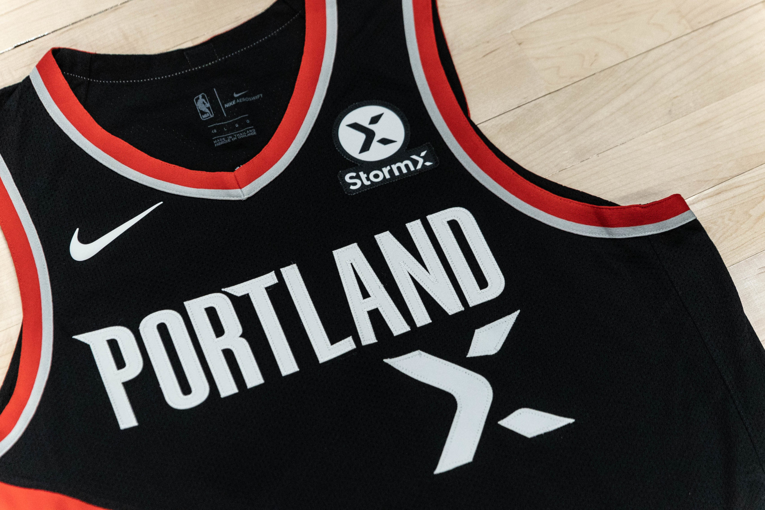 The StormX logo on the official Portland TrailBlazers basketball jersey.