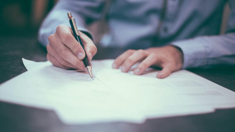 man proofreading documents